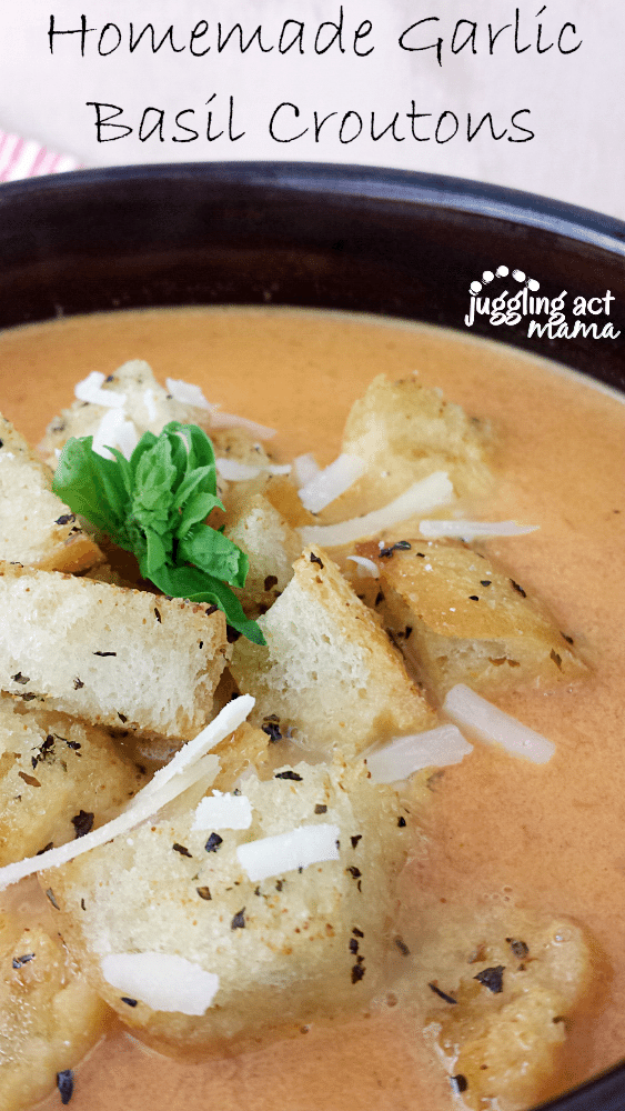 Close up image of Homemade Garlic Basil Croutons on top of tomato soup.