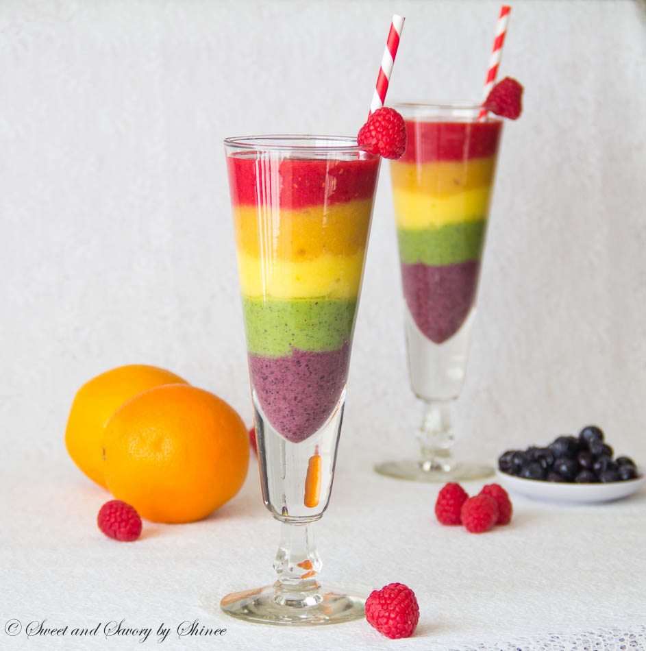 Rainbow Smoothies in fun glasses with straws.