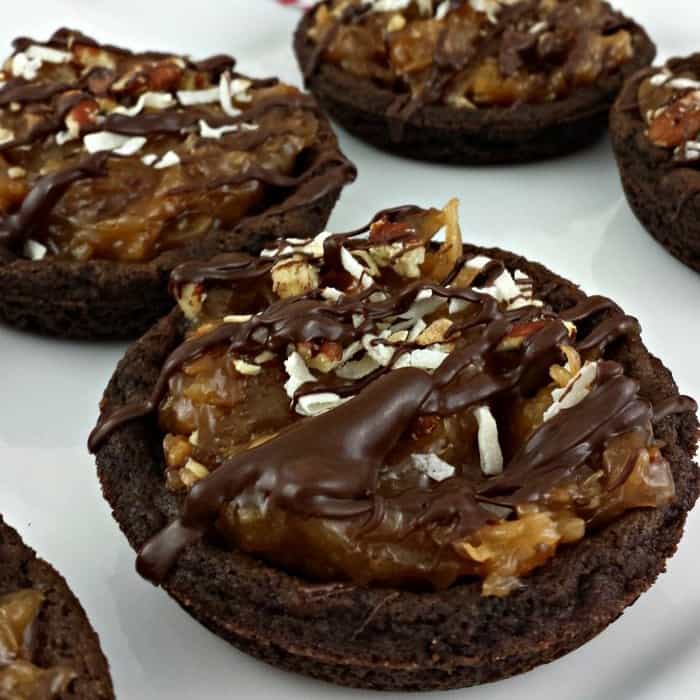 Close up image of a German chocolate cookie pie on a white plate.