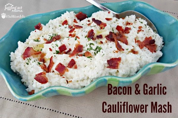 Cheesy Bacon and Garlic Cauliflower Mash in a serving dish with a spoon.