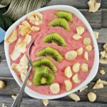 Top down image of a tropical strawberry pineapple smoothie bowl.