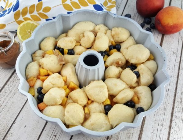 How to make Blueberry Monkey Bread: dough and fresh fruit in a bundt pan.