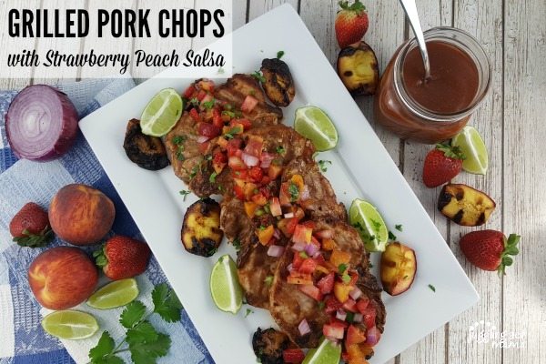 Grilled Pork Chops + Strawberry Peach Salsa on a white platter.