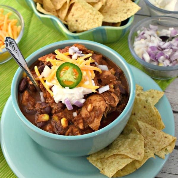 Bowl of chicken chili with sour cream.