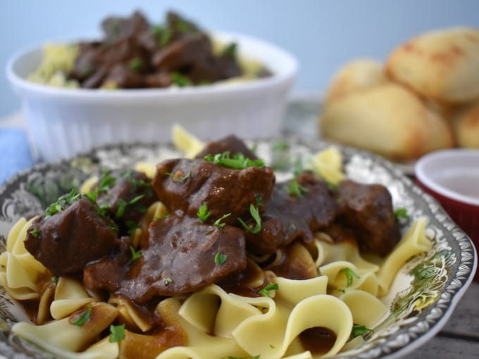Beef Tips with Gravy in a bowl with egg noodles.