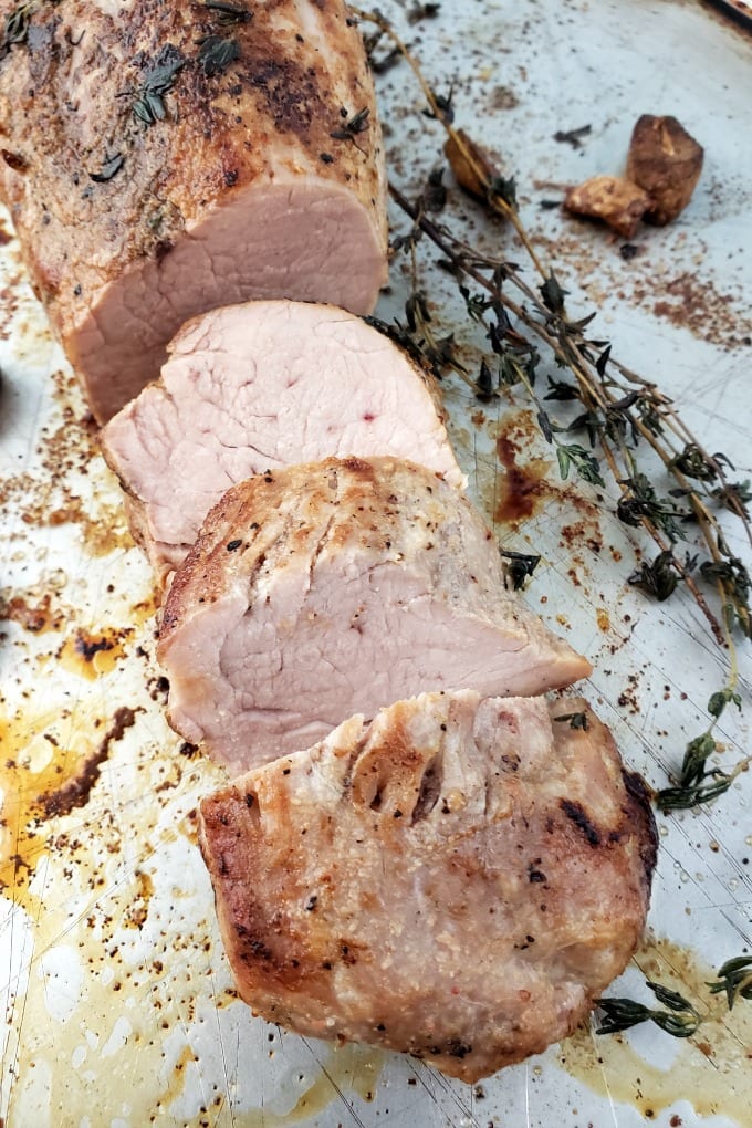 Oven Roasted Pork Tenderloin - Succulent pork tenderloin with garlic and thyme, finished with Cowboy Butter and ready in about 40 minutes! via @jugglingactmama