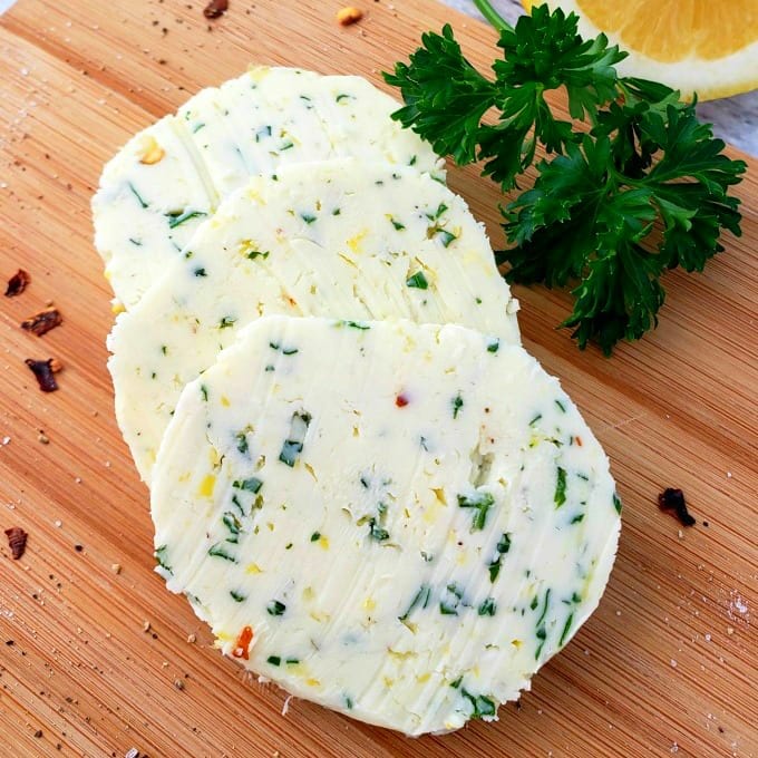 compound butter on a cutting board with parsley