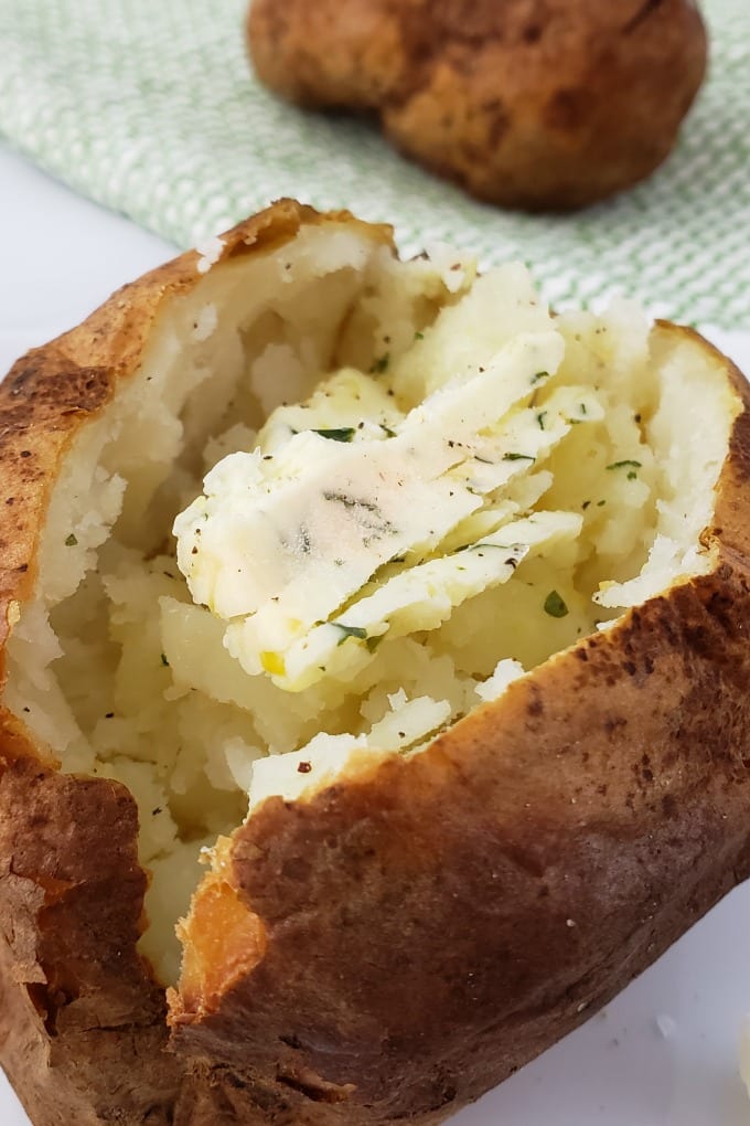 Close up of a baked potato topped with Cowboy Butter