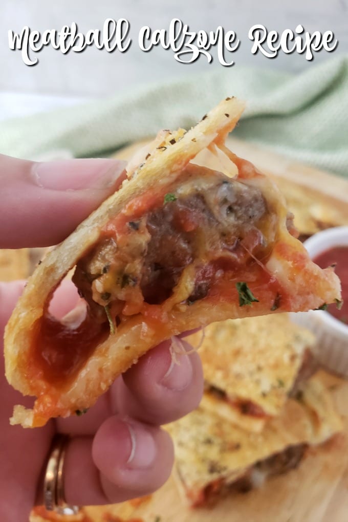 Meatball Calzone - with savory tomato sauce, gooey mozzarella, colby jack cheeses and Italian meatballs, this is pretty much guaranteed to be the best meatball calzone you've ever tasted! via @jugglingactmama