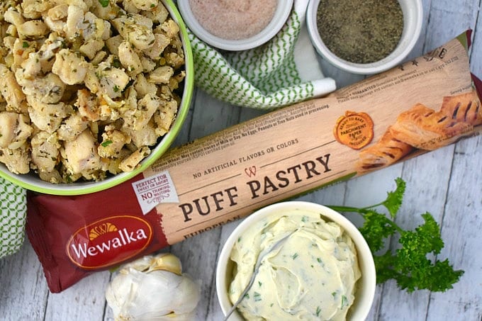 Package of Wewalka Puff Pastry Dough next to a green hand towel, cooked chicken, herb cheese, salt and pepper.