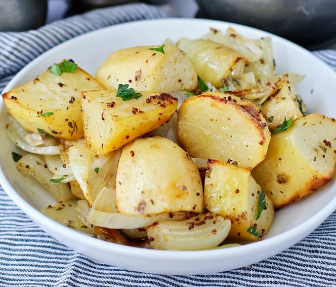 Roasted onions and potatoes in a bowl. 