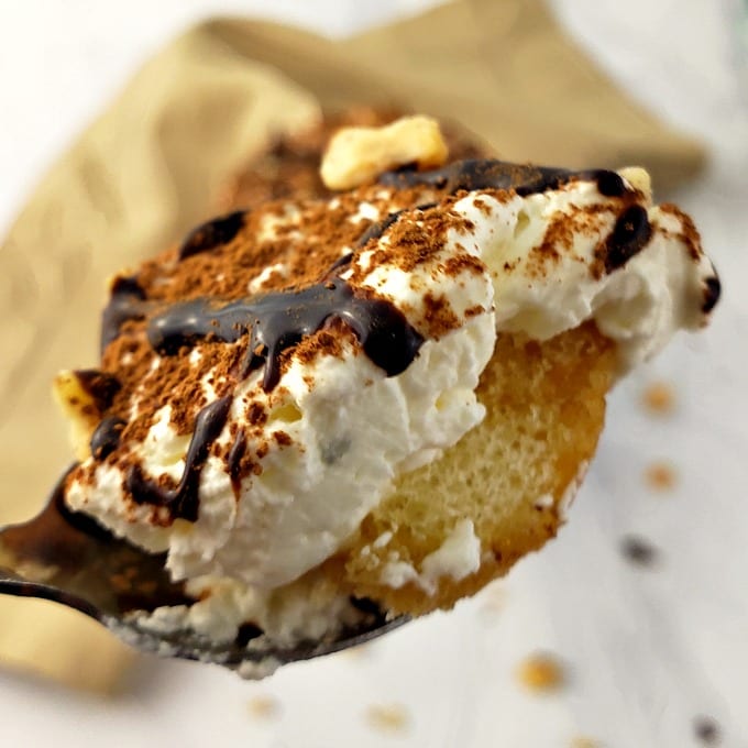 Close up of a spoonful of tiramisu cup dessert