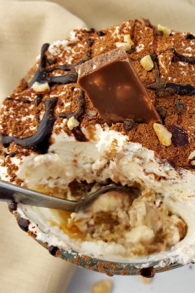 Close up of a spoonful of tiramisu cup dessert