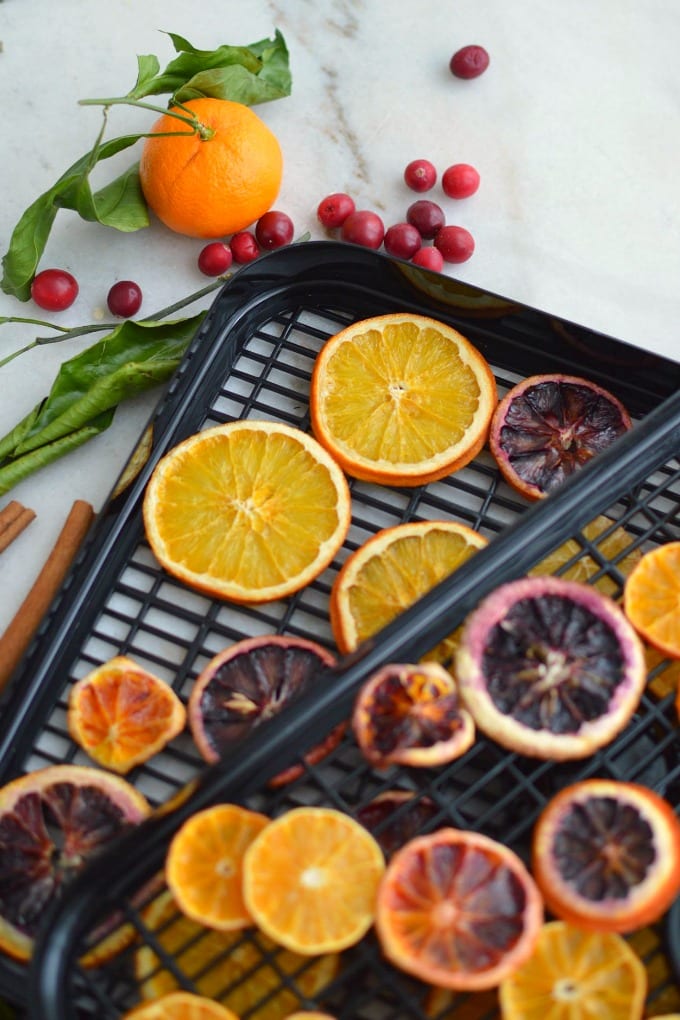 Beautiful dried orange slices for ornaments are a wonderful way to add homemade rustic charm to your holiday décor this Christmas! Get step-by-step instructions for drying citrus in the oven or using a dehydrator. Add to garland and wreaths or make ornaments. via @jugglingactmama