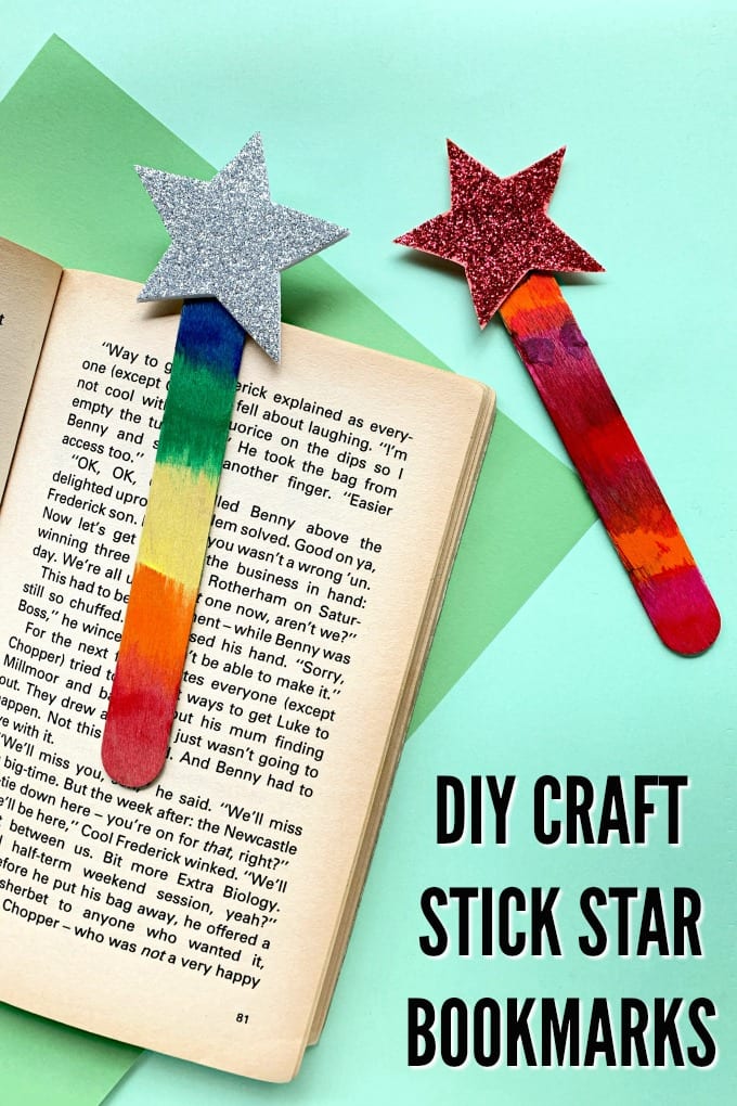 Bookmarks made from craft sticks on top of an open book.