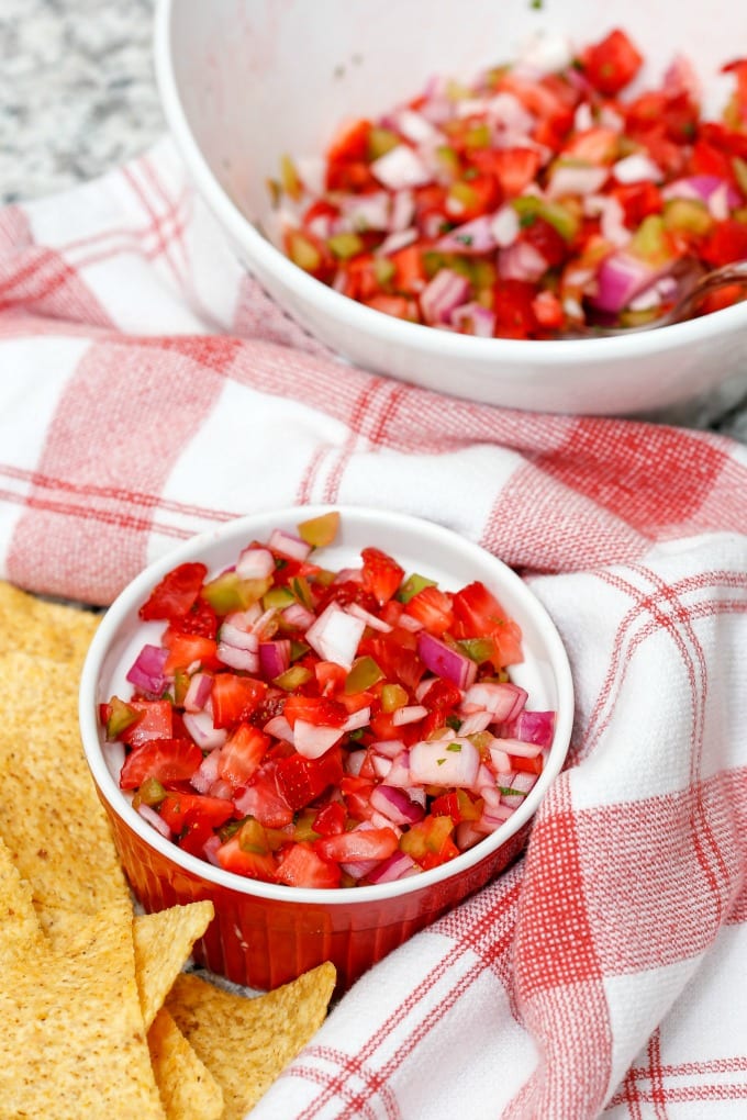 Strawberry Salsa is a fresh new take on a classic. Sweet with a little heat that can be adjusted easily to taste. You may never buy jar salsa again! via @jugglingactmama