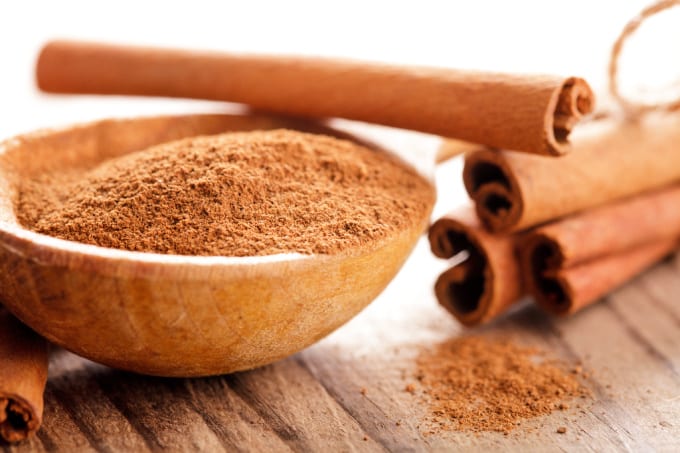 Cinnamon can be used as a homemade rooting hormone - 
close up of a bowl of ground cinnamon with cinnamon sticks