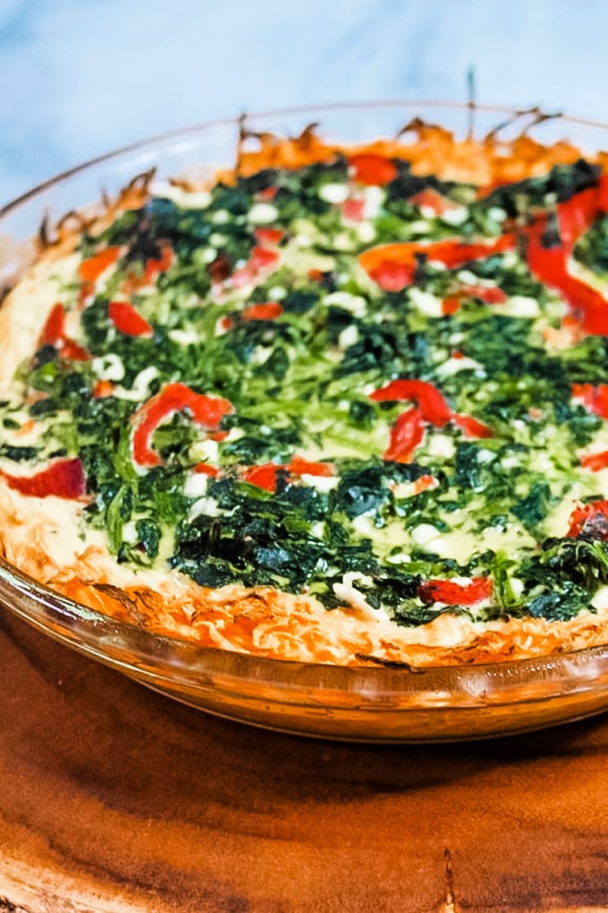 Picture of sweet potato spinach and feta quiche in a glass pie plate.
