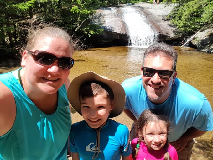 Family of four at Beede Falls Sandwich NH with the waterfall in the background.