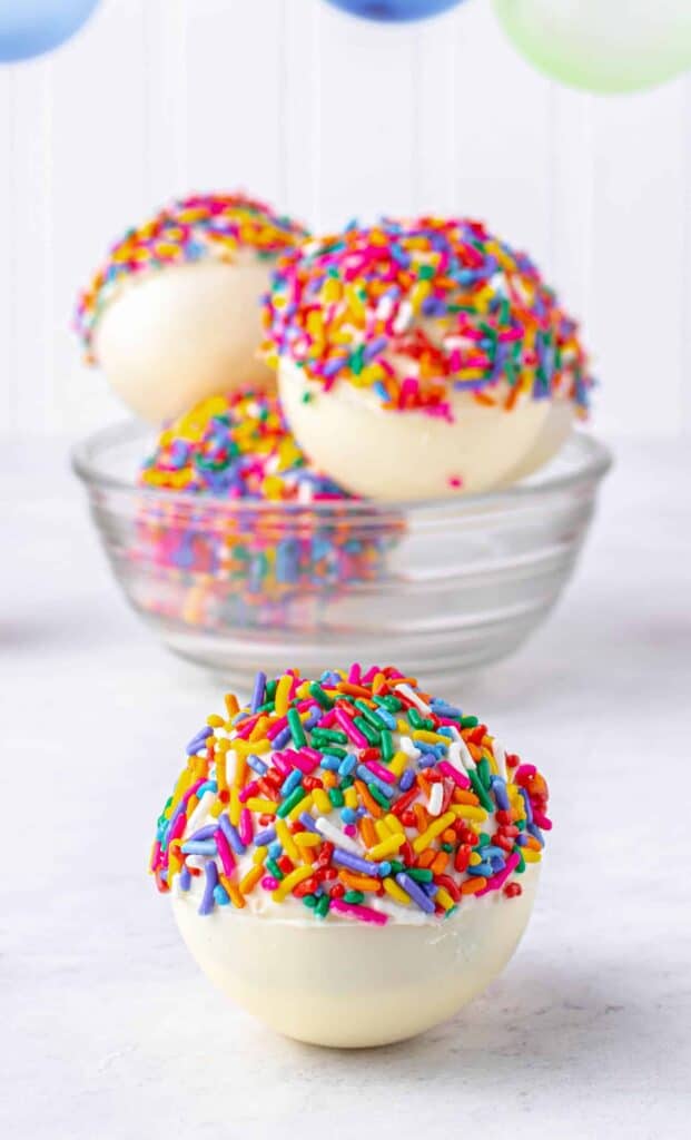 Birthday Hot Cocoa Bombs, white with colored sprinkles.
