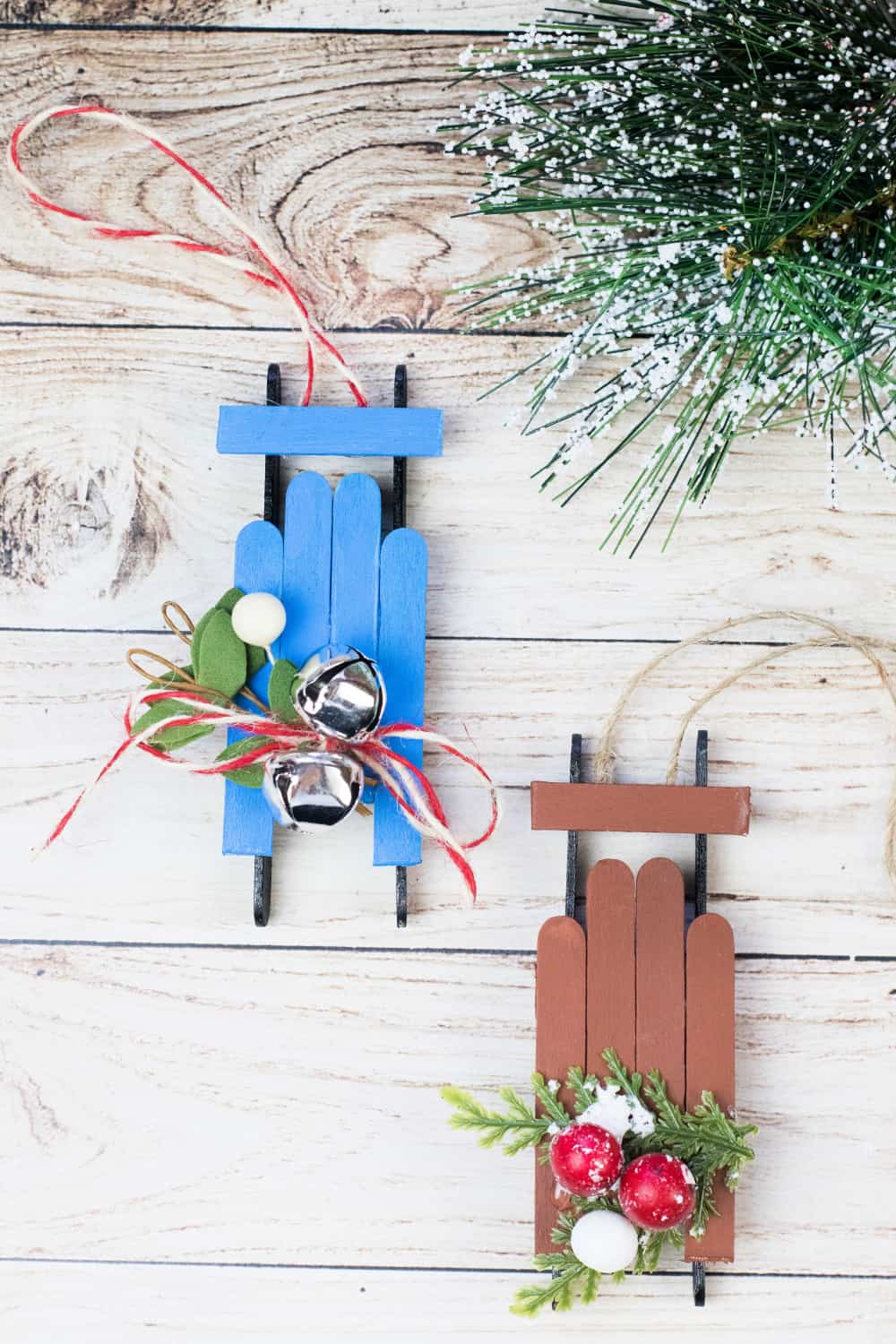 You can make these adorable Popsicle Stick Sled Ornaments in no time with some simple supplies from your favorite dollar store! via @jugglingactmama