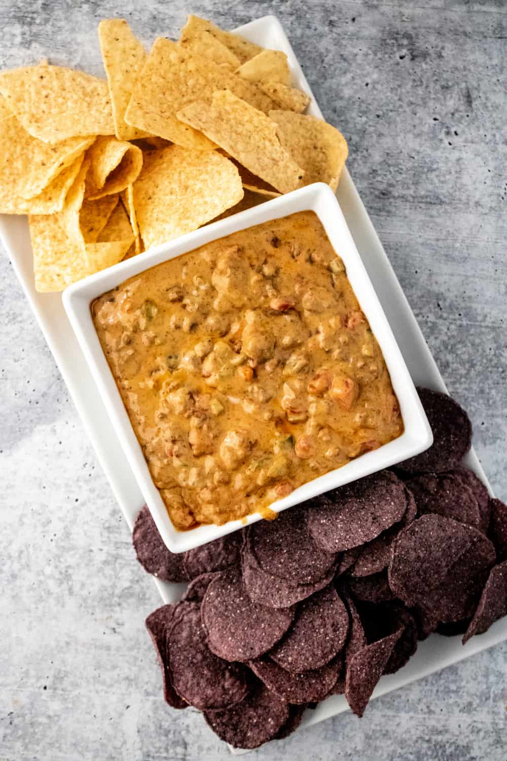 Beef Queso Dip combines a beef mixture with melted cheese and spices. For perfect party food, you need this delicious cheesy appetizer. via @jugglingactmama