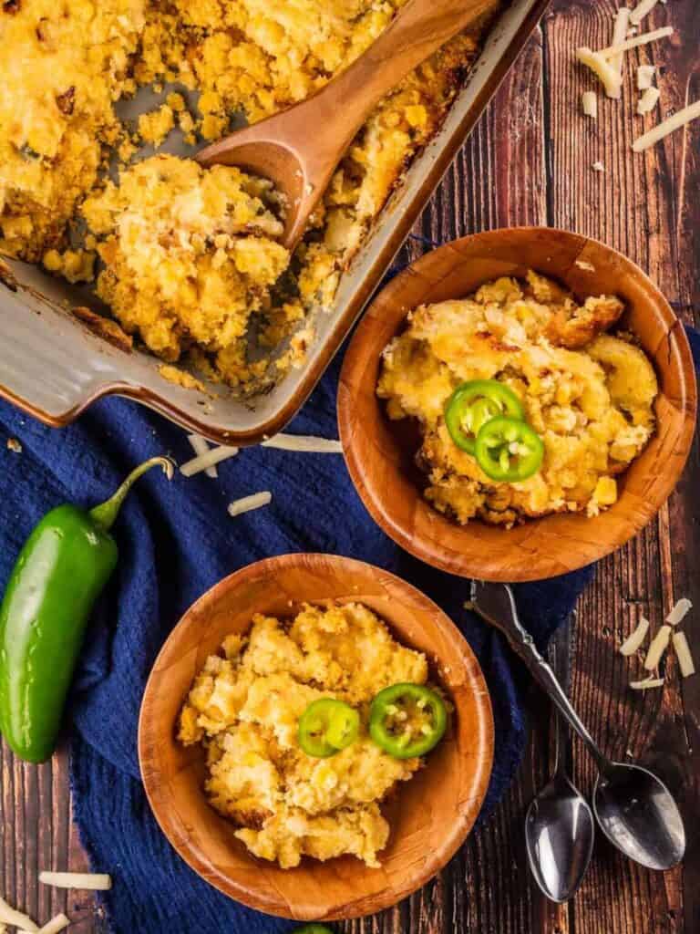 Bowls of Cornbread Pudding topped with jalapeno pepper slices.