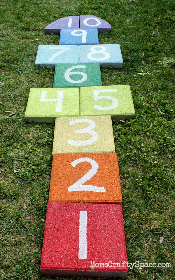 Easy Homemade Lawn Games - Hopscotch made from rainbow painted pavers.