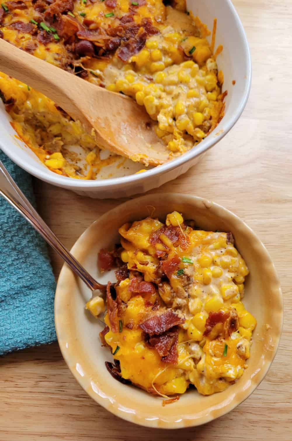 Close up of Cowboy Corn Casserole in a white baking dish next to an individual portion in a small bowl.
