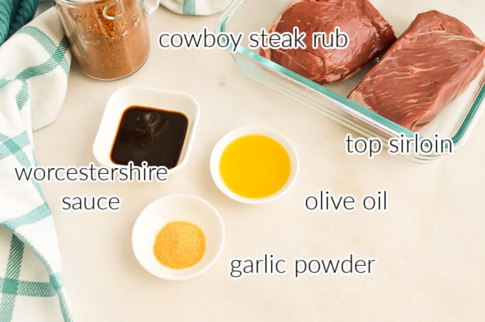 Ingredients in small bowls plus top sirloin in a baking dish.