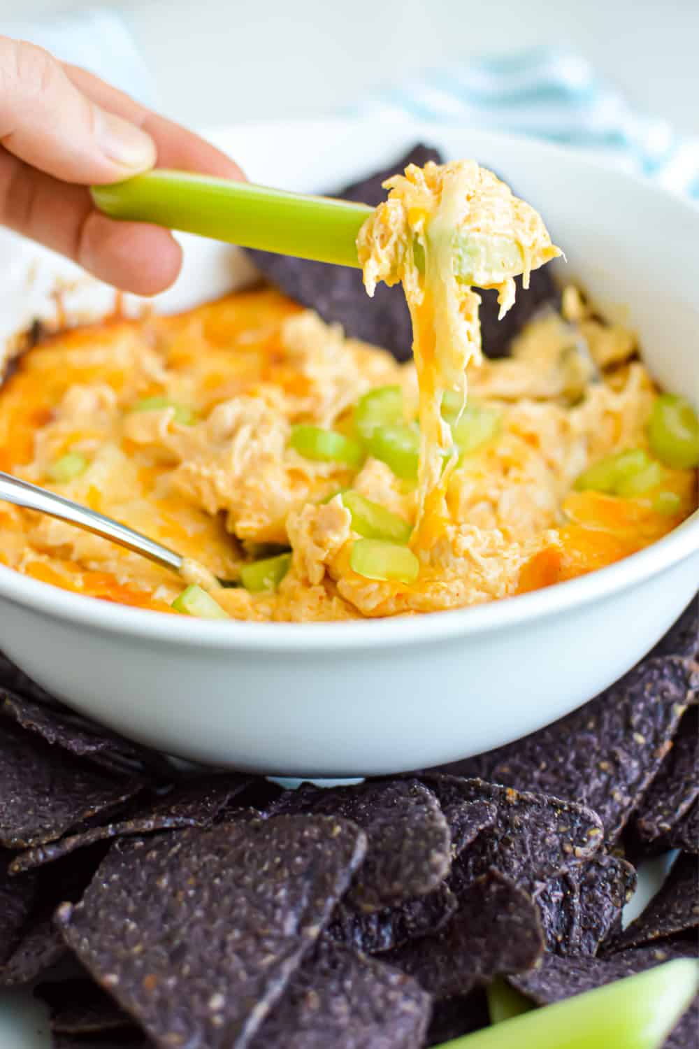 Easy Buffalo Chicken Dip Recipe is so simple to make! Loaded with blue cheese, Frank's Red Hot Sauce and baked in the oven until hot and bubbly! You can used canned chicken or rotissiere. This dip is one of our most popular recipes of all time. It's a simple game day staple and you can even make it ahead! #chickendip #buffalodip #jugglingactmama #tailgatingfood via @jugglingactmama