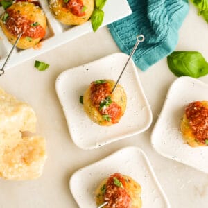 Square image of Keto Chicken Meatballs on small appetizer plates.