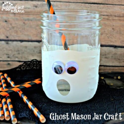 Close up of ghost mason jar craft with paper straws.