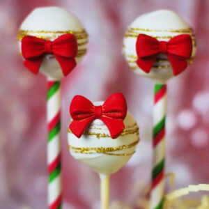 Close up of Christmas Cake Pops with red bows.