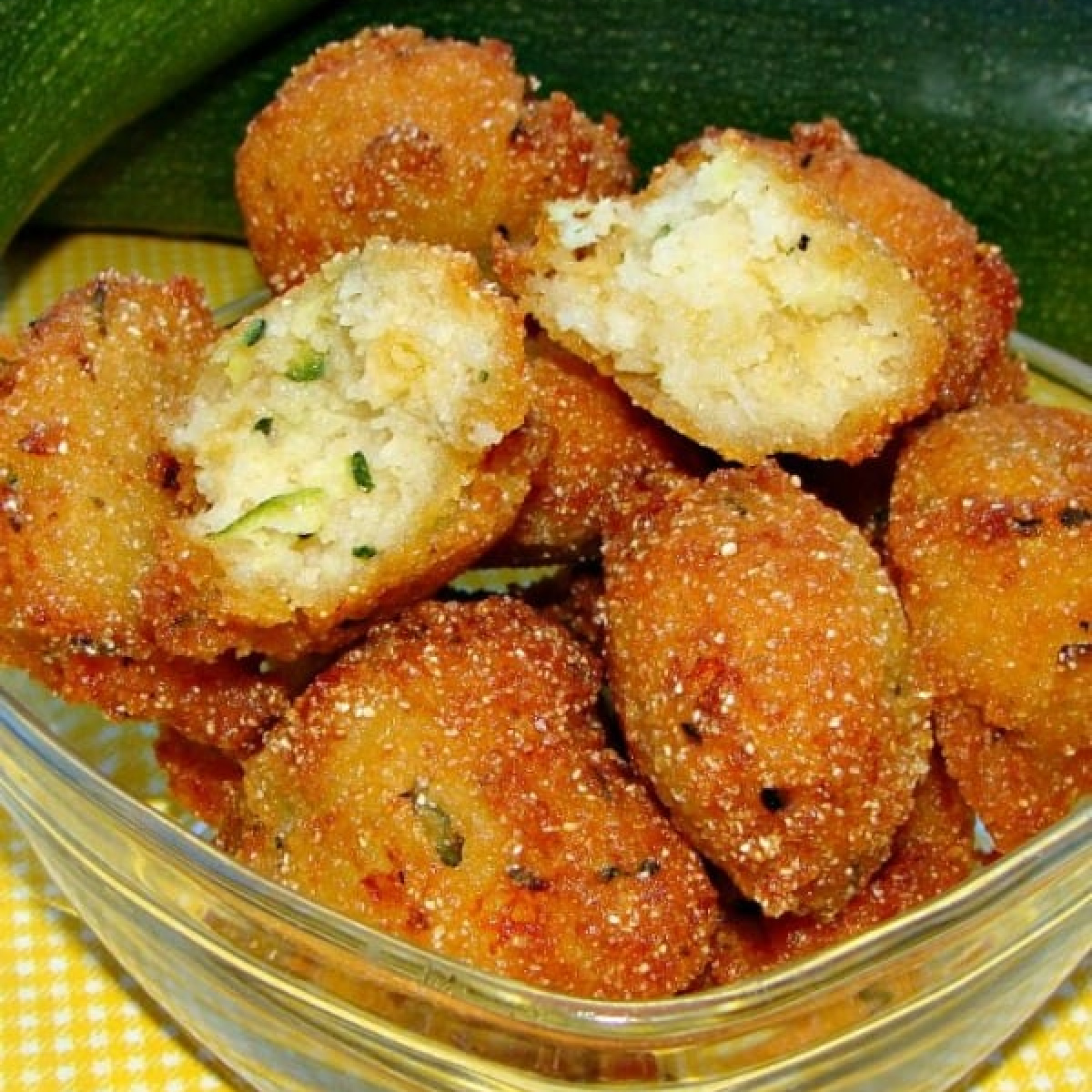 Zucchini Hush Puppies piled in a dish..
