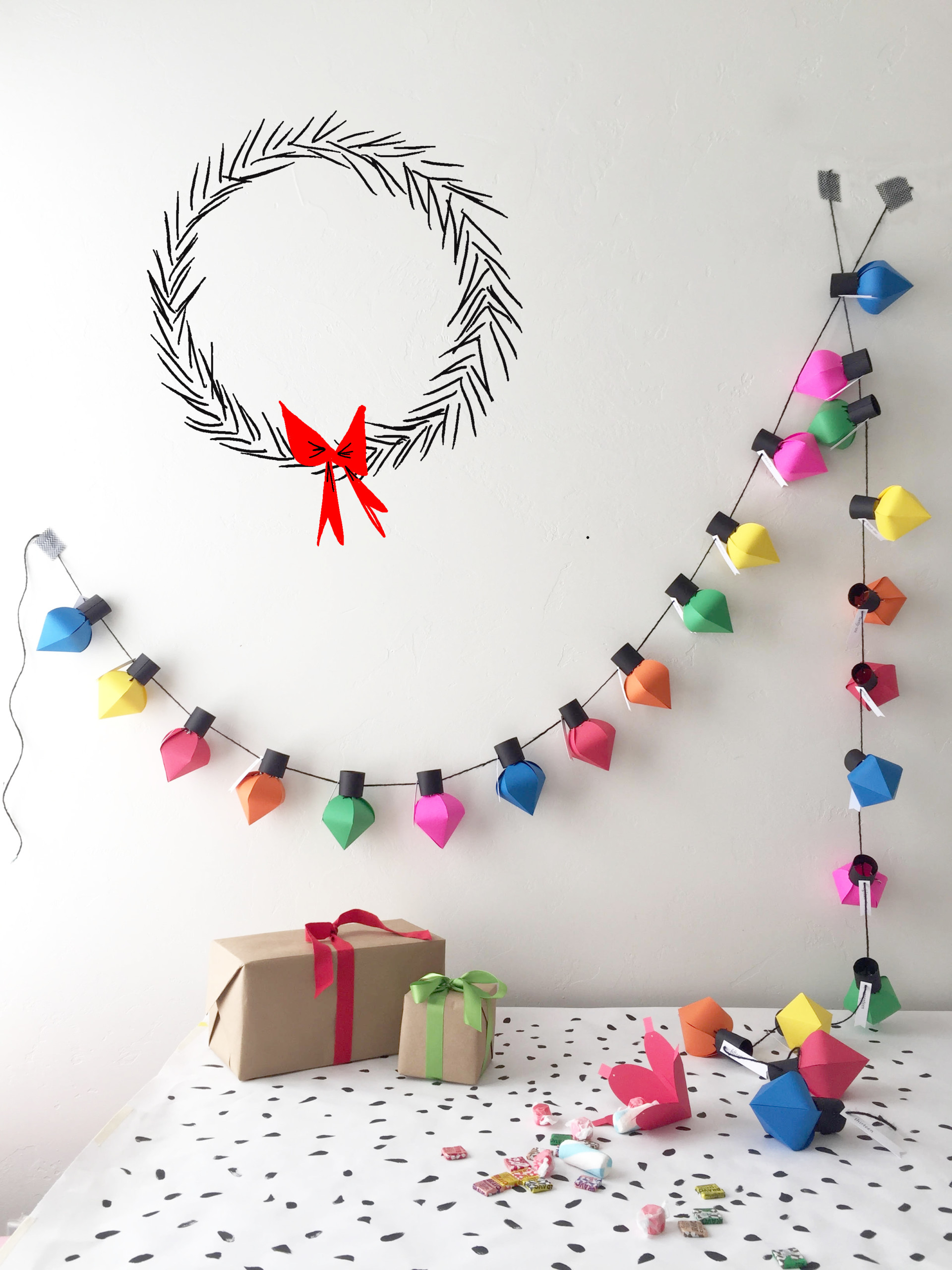 DIY Christmas Bulb Advent Calendar handing on a wall.