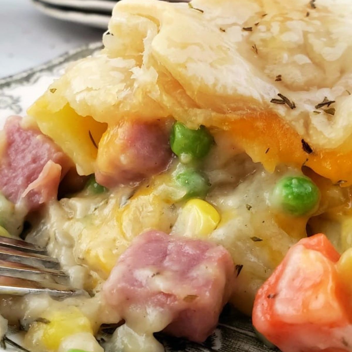 Close up of Ham Pot Pie on a plate witha fork.