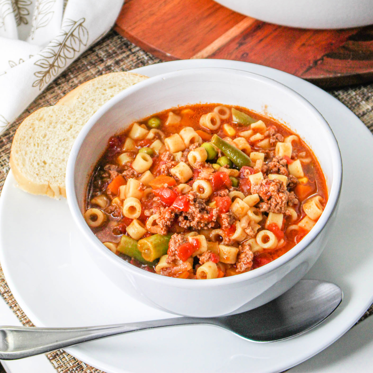 Bowl of Busy Day Soup on a plate with a spoon.