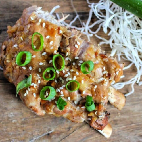 Sesame Ginger Instant Pot Ribs with scallions on a cutting board.