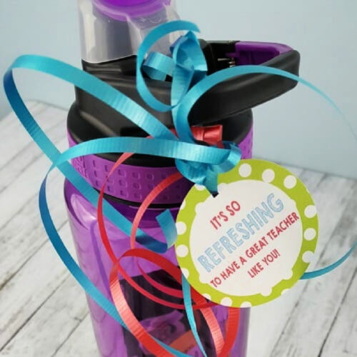 Water btottle with gift tag and curling ribbon.
