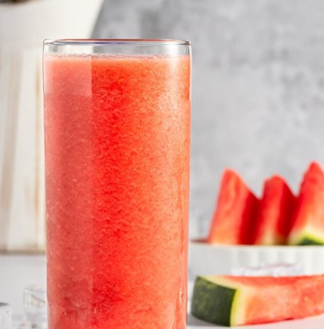 Banana Watermelon Smoothie in a tall glass with watermelon slices.