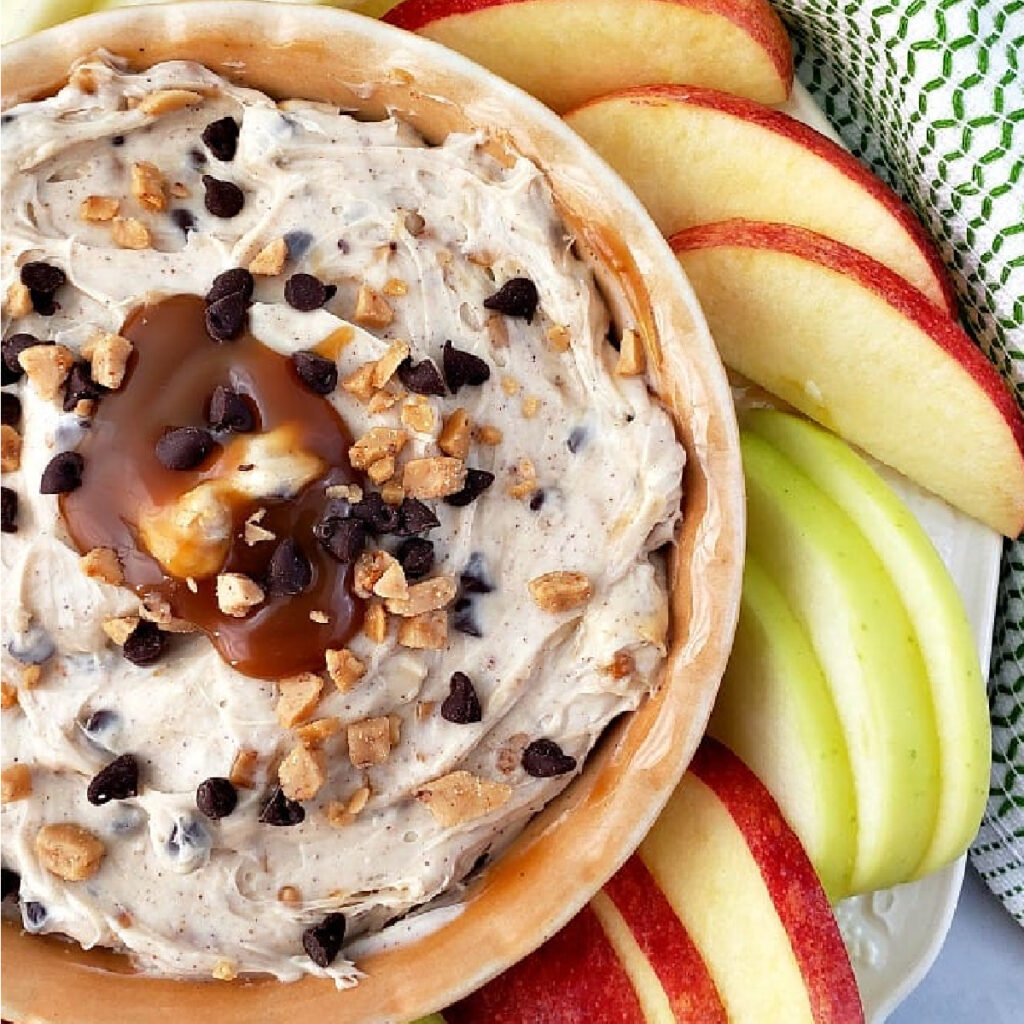Apple Toffee Dip in a small bowl surrounded by pear and apple slices.