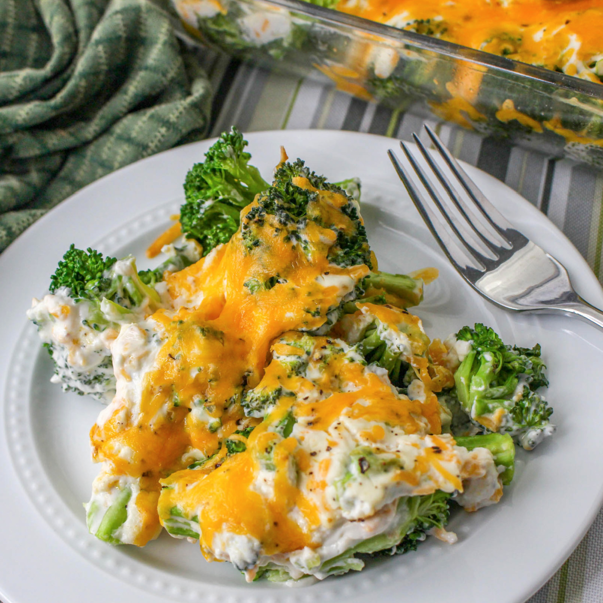 White plate of Low Carb Broccoli Casserole with a fork.