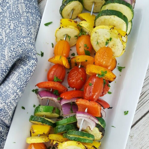 Grilled Rainbow Vegetable Kabobs on a white platter.
