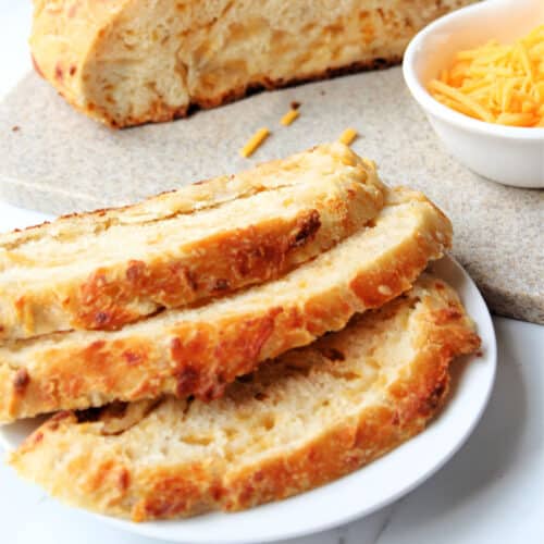 Close up of Dutch Oven Cheddar Cheese Bread on a plate.