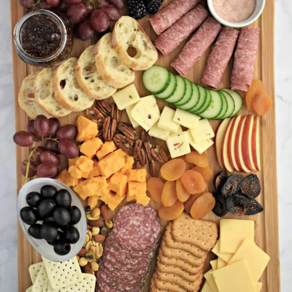 How to Make a Meat and Cheese Tray: variety of meats, cheeses, dried fruits, and nuts.