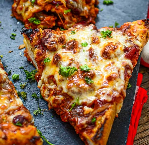 3 Ingredient Chili Cheese Toast on a slate cutting board.
