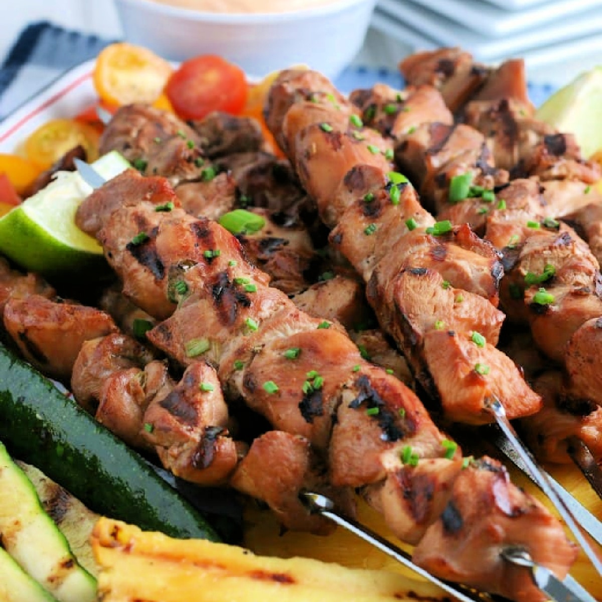 Close up of Platter of Grilled Chicken on skewers.