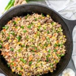 Steak Dinner Ideas: Steak Fried Rice in a skillet with garlic, ginger, and green onions.