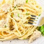 Close up of a fork with Garlic Parmesan Chicken and Pasta.